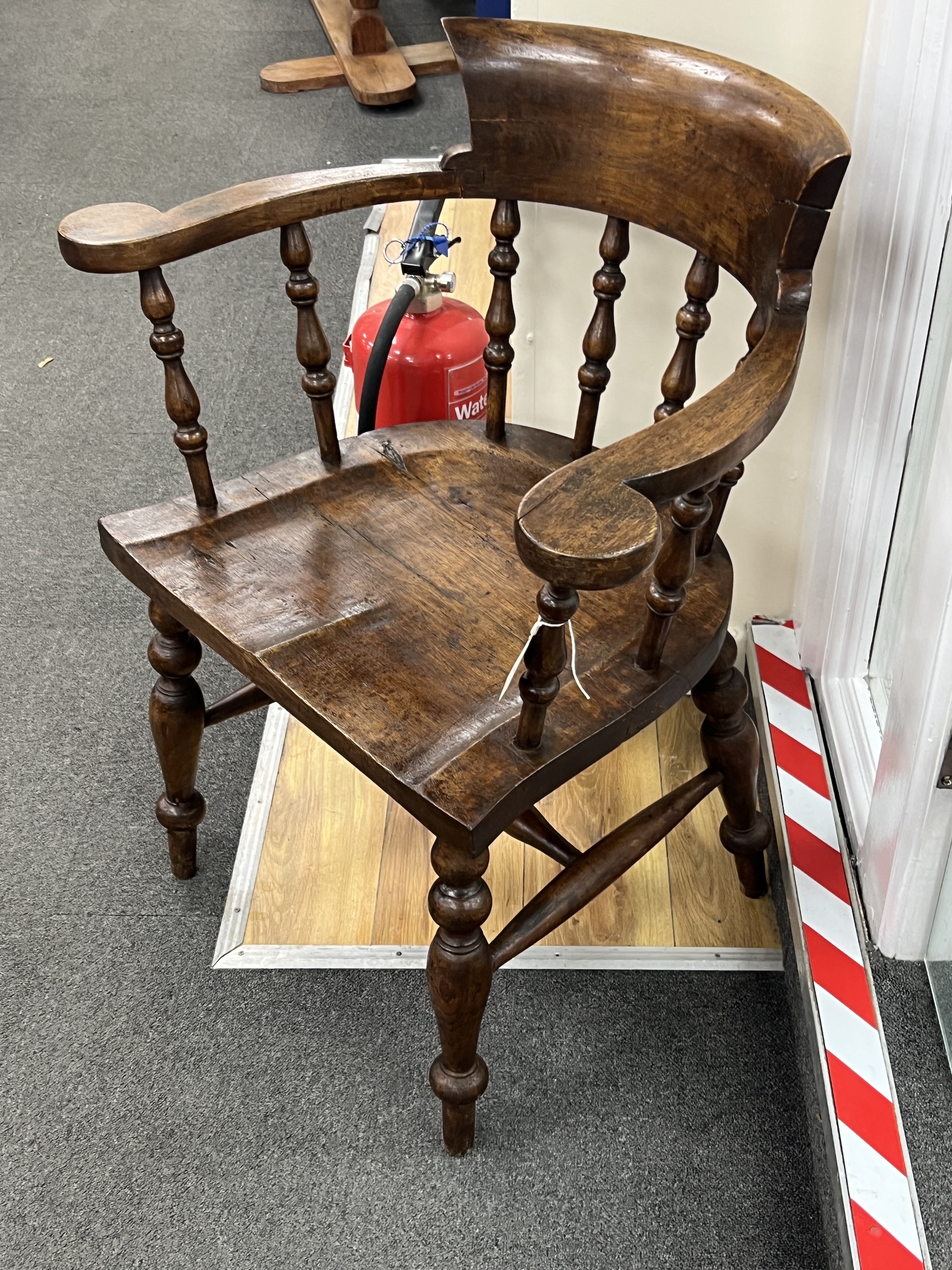 A Victorian style smoker's bow elbow chair, width 72cm, depth 47cm, height 84cm